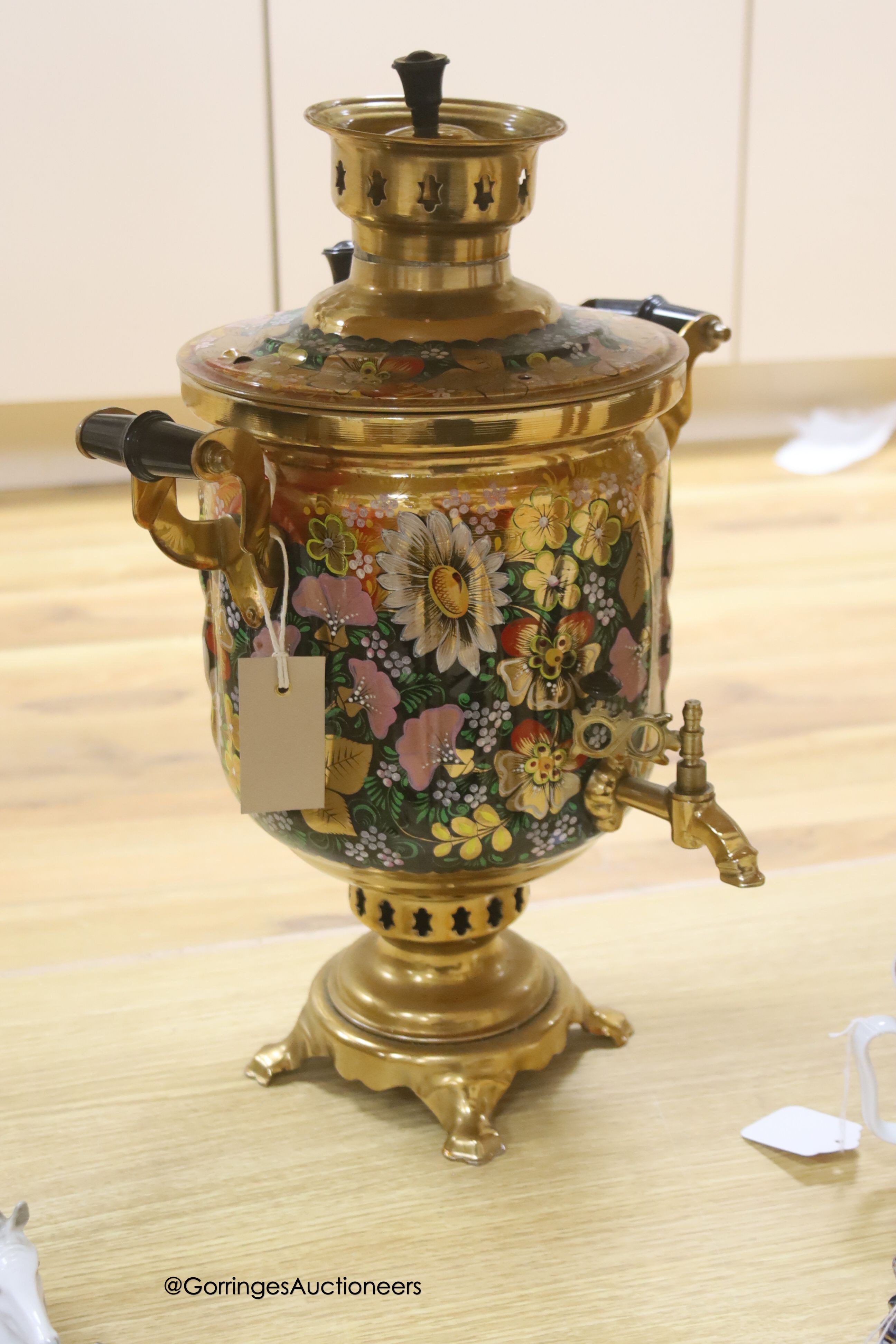 A Russian gilt samovar painted with flowers and a small collection of Russian ceramics